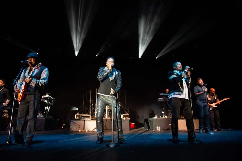 Tito Jackson, Marlon Jackson, and Jackie Jackson of the Jacksons perform on stage at Wolf Creek Amphitheater